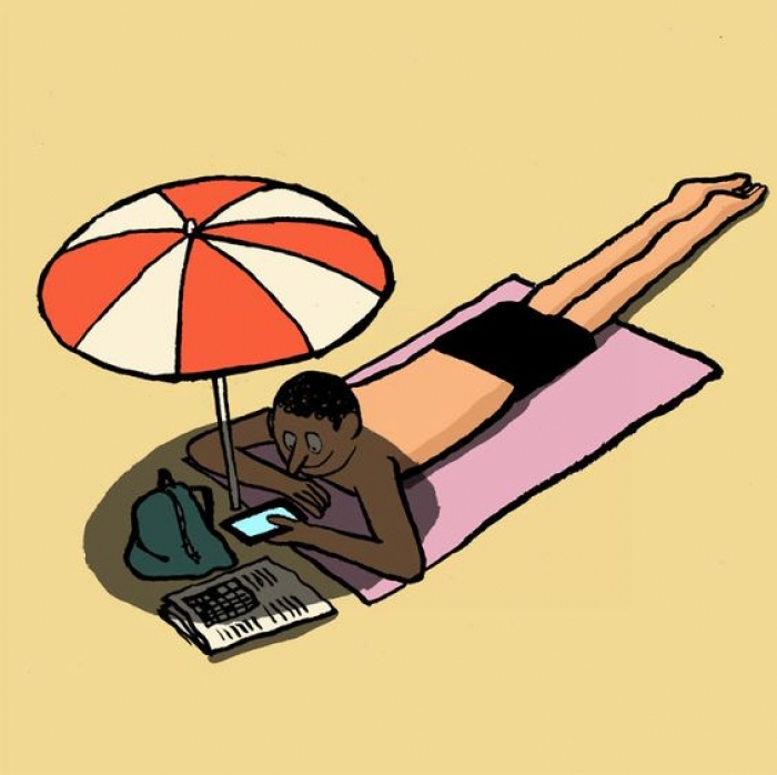 man-lying-on-the-beach-with-his-mobile